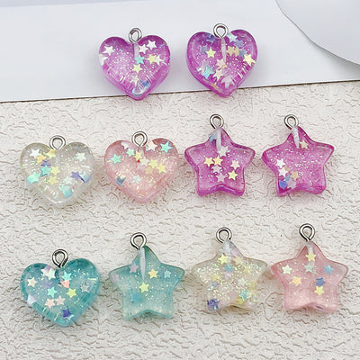 Clear heart and star charms arranged on a light background