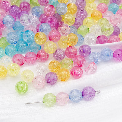 Clear round bead and bead beads arranged on a light background