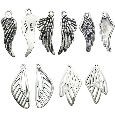 Antique silver dragonfly charms arranged on a light background