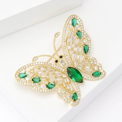green crystal butterfly brooch with openwork wings isolated on a white background
