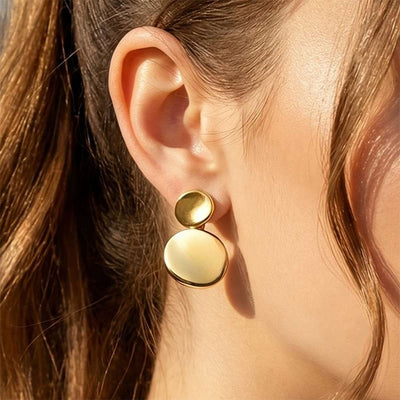 On-ear view of double disc drop earrings in main image 1.