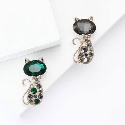 Faceted Crystal Cat brooch In Emerald Green And Black shown in front view on a light background