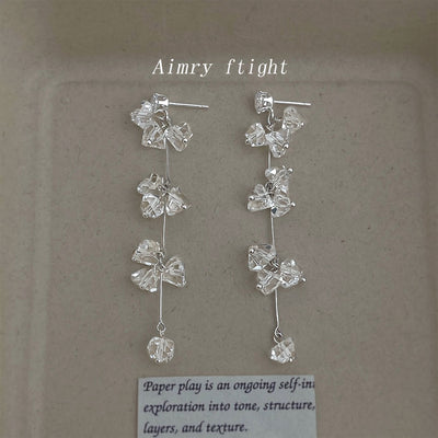 Silver clear glass crystal butterfly tassel drops on beige board