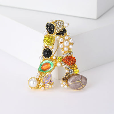 Front view of the multicolor crystal letter a brooch with pearl accents on a white background