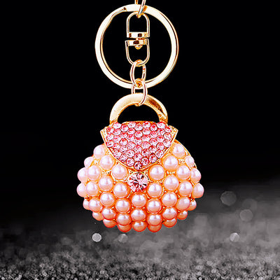 Main image 1 shows the Pink Pearl-Handbag option with its visible attached key hardware.