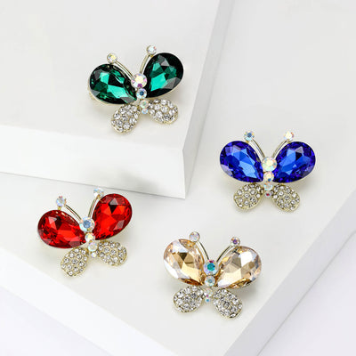 Front view of the double gem butterfly brooch in four colors with polished metal detail on a white background