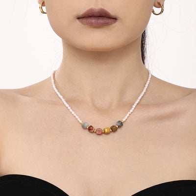 White pearl choker with multicolor natural stone center beads on model
