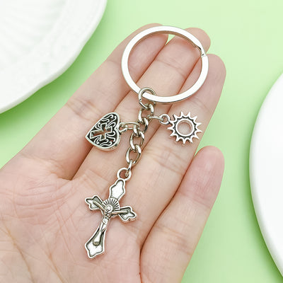 Image 1 showing a hand holding a silver keychain.