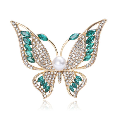 Front view of a large open-wing butterfly with crystal panels and pearl body accents
