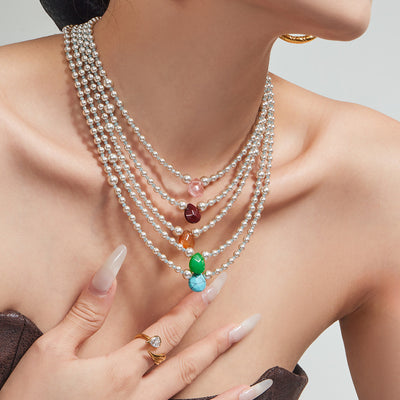 Five layered pearl teardrop pendant necklaces worn stacked