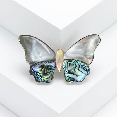 Front view of abalone and Shell Effect Butterfly Brooch With Gold Tone Body against a white background.