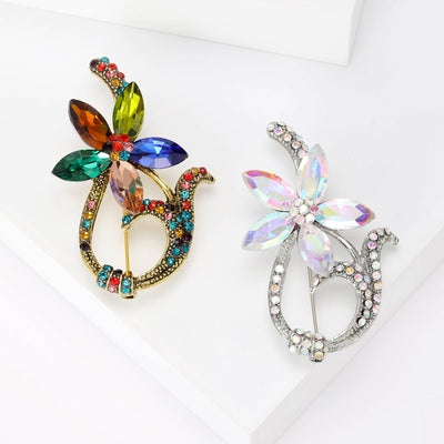 Front view of the glass petal wreath brooch in multicolor or clear with polished metal detail on a white background