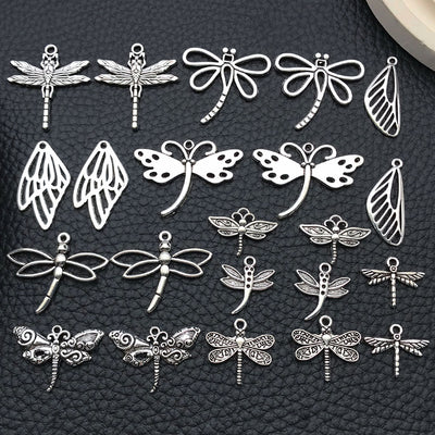 Blue dragonfly charms arranged on a light background