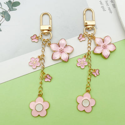 Image 1 showing a pair of pink flowers hanging from gold-tone hooks.