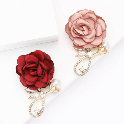 Front view of the fabric rose brooch with crystal loop in pink and red brooch and its color options