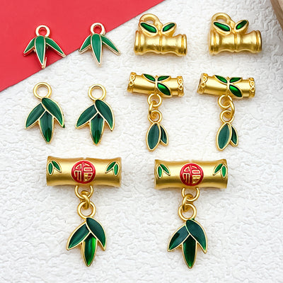 Matte gold-tone assorted shape charms arranged on a light background