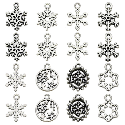 Metallic snowflake charms arranged on a light background