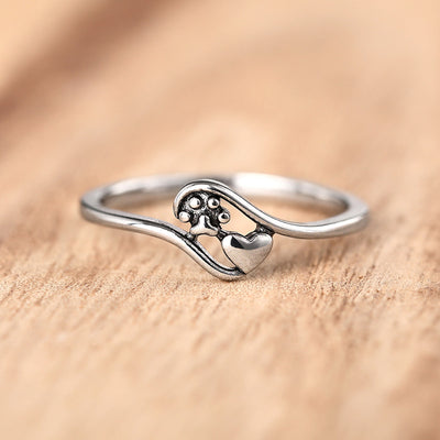 Product view showing heart and tree motif ultra-slim ring in silver tone
