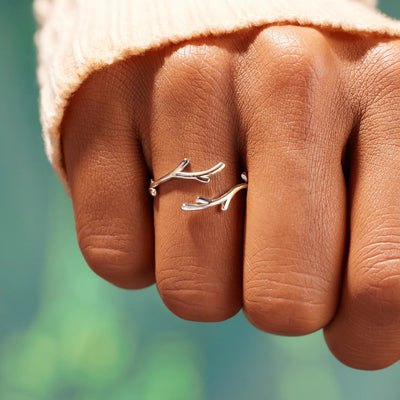 Silver open antler branch ring worn on hand outdoors in sunlight