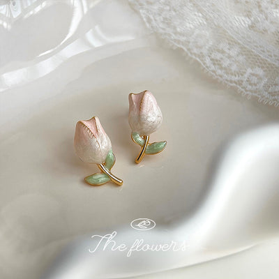 Pink tulip bud studs with mint leaves on white satin