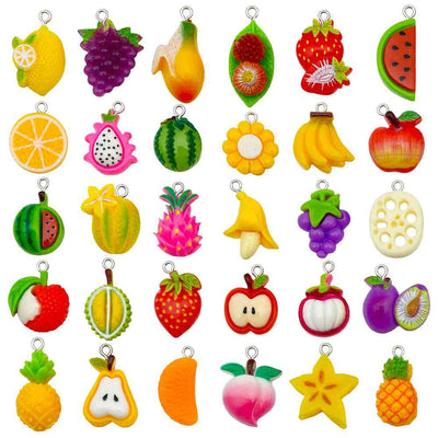 Multicolor banana and strawberry charms arranged on a light background