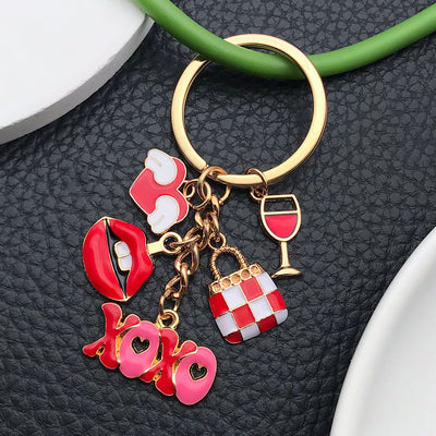 Overview showing the available color and design variations of the red XOXO lips heart and wine glass metal keychain