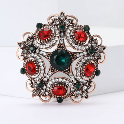 Copper tone red green crystal baroque floral brooch front view