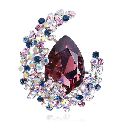 Front view of large teardrop crystal swirl brooch in purple and blue
