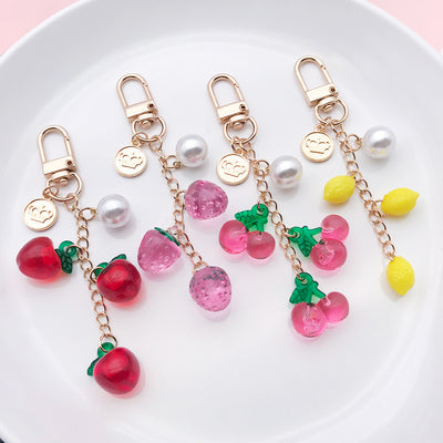 Image 1 showing a white plate with fruit charms on it.