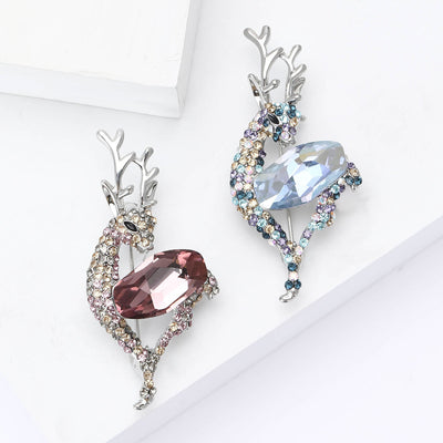 Two colorways of crystal antlered deer brooch with one oversized oval body stone shown side by side.