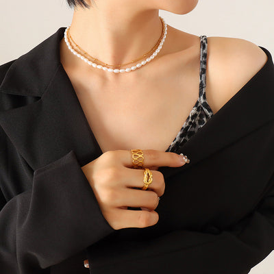 Gold double layer pearl and chain necklace worn with black blazer