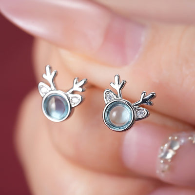 Image 1 showing blue center reindeer stud earrings