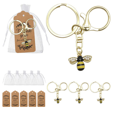 Gold bee rhinestone wing keychains with white organza bags and kraft tags