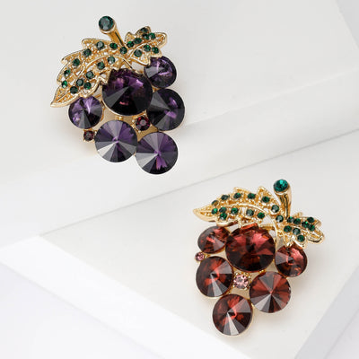 Front view of vintage crystal grape cluster brooch in purple and amber