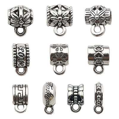 Antique silver connector clasp jewelry findings arranged on a light background