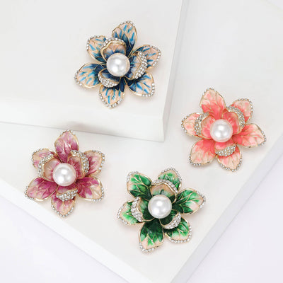 Front view of the layered enamel flower brooch with pearl center decorative clothing pin on a white background