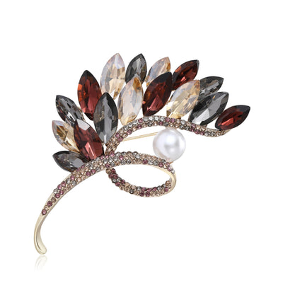 Brown Wheat, Blue Wheat brooch styles arranged on a light display