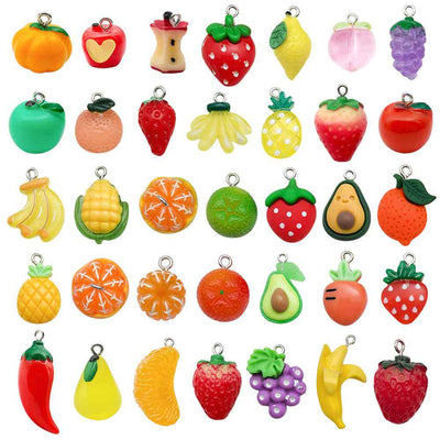 Multicolor lemon and strawberry charms arranged on a light background