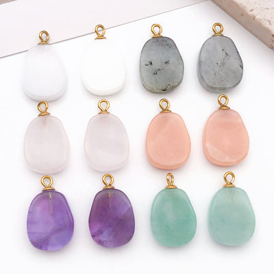 Metallic assorted shape charms arranged on a light background