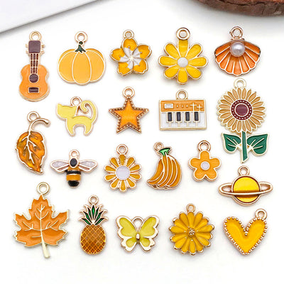 Colorful flower and leaf charms arranged on a light background