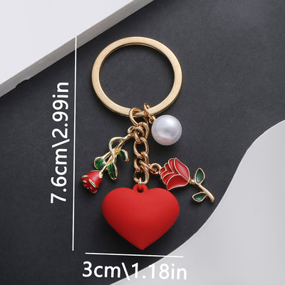 Front product photo of red rose heart and faux pearl charm keychain with round ring showing the pictured design arrangem