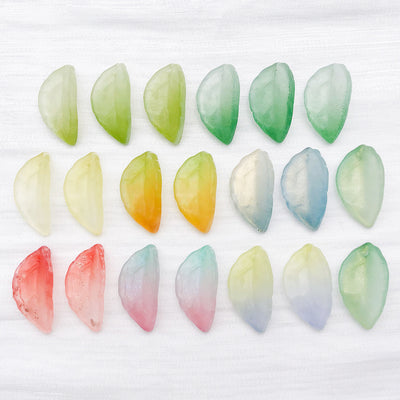 Colorful leaf charms arranged on a light background