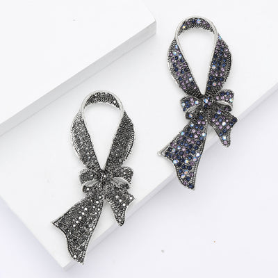 Front view of the black crystal ribbon bow brooch decorative clothing pin on a white background