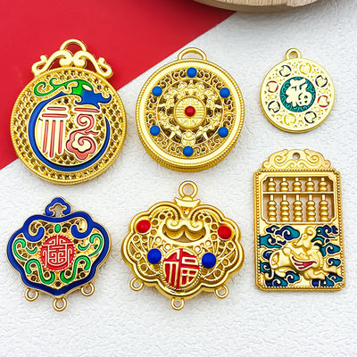 Gold-tone tag charms arranged on a light background