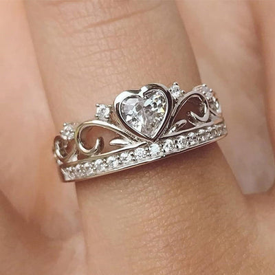 Silver heart crown clear CZ ring worn on finger close-up