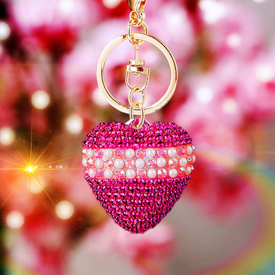 Main image 1 shows a supplied presentation of pearl band crystal heart keychains with visible attached key hardware.