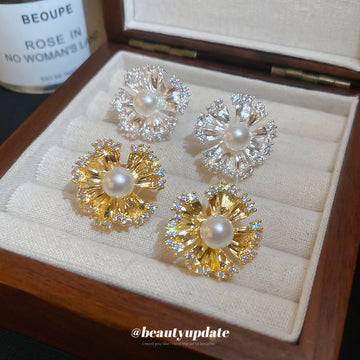 Pearl Center Radiating Flower Clip On Earrings With Polished Metal Details