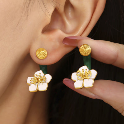 Gold ridged posts and white enamel flower drops on green C-curves near ear