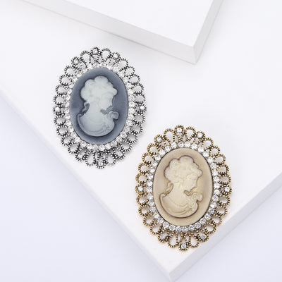 Oval Cameo Portrait Brooch With Crystal Filigree Border shown from the front on a white background