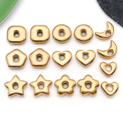 Gold-tone spacer bead beads arranged on a light background